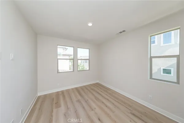 a front view of a house with a garden and plants