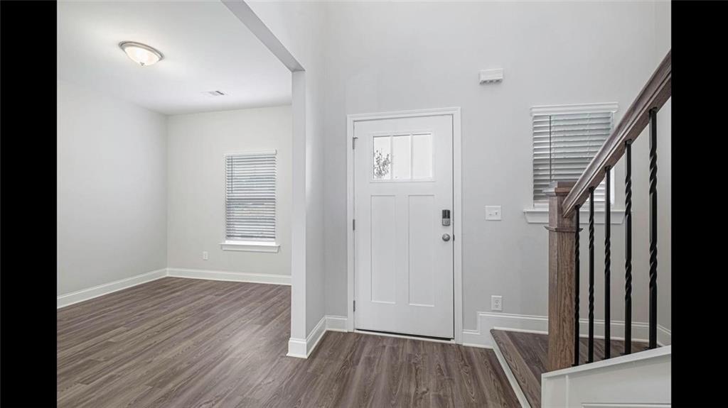 3792 Oak Rdg Drive, Unit HASTINGS Buford, GA 30519 - Photo 11 of 32 an empty room with wooden floor and a window