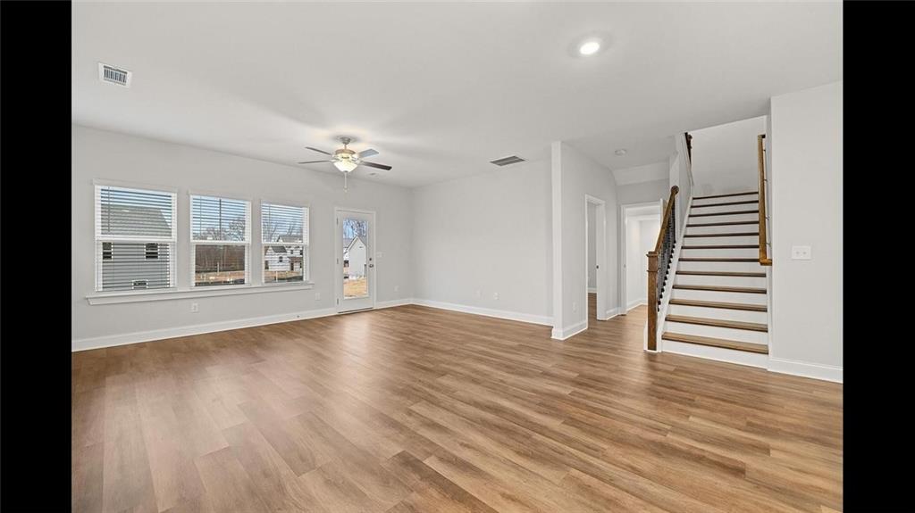 3792 Oak Rdg Drive, Unit HASTINGS Buford, GA 30519 - Photo 13 of 32 a view of an empty room with wooden floor and a window
