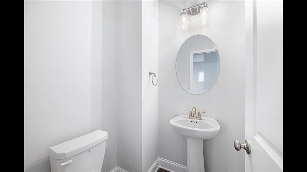 3792 Oak Rdg Drive, Unit HASTINGS Buford, GA 30519 - Photo 19 of 32 a bathroom with a sink a toilet and a mirror