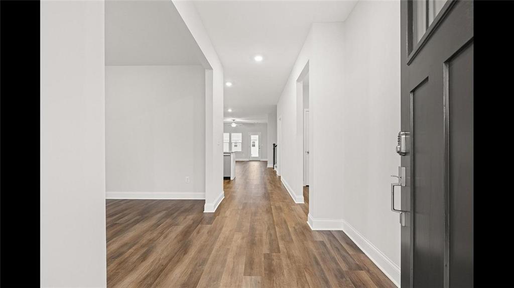 3792 Oak Rdg Drive, Unit HASTINGS Buford, GA 30519 - Photo 28 of 32 a view of a hallway with wooden floor