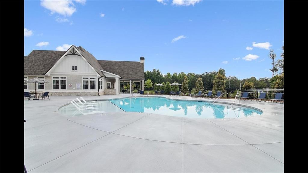 3792 Oak Rdg Drive, Unit HASTINGS Buford, GA 30519 - Photo 3 of 32 a view of house with swimming pool and view of a lake