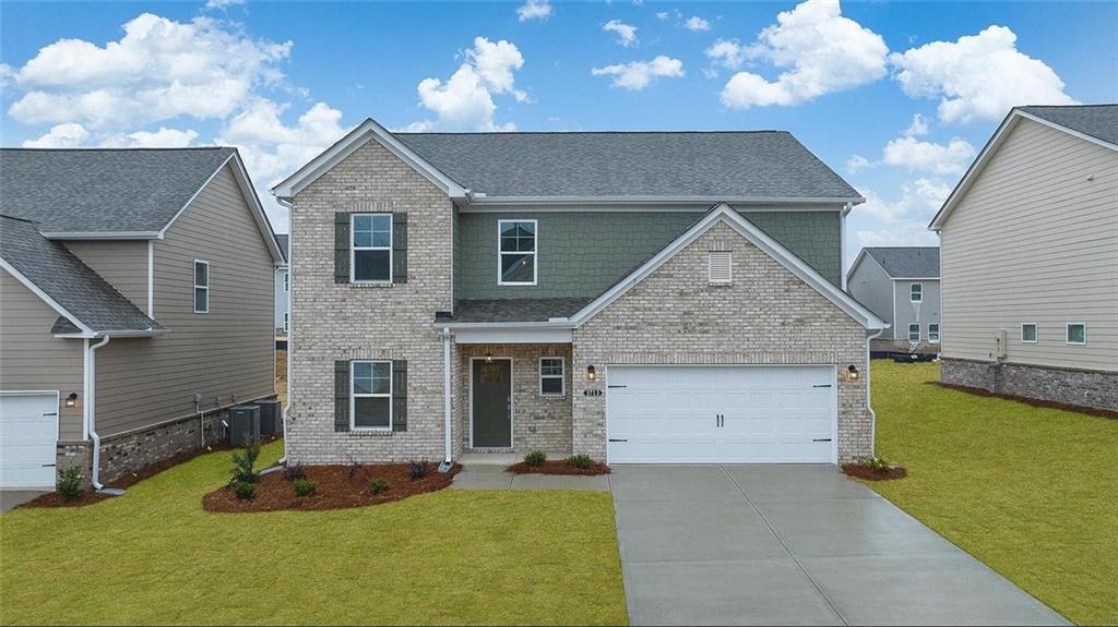 3792 Oak Rdg Drive, Unit HASTINGS Buford, GA 30519 - Photo 31 of 32 a view of a house with a yard and a garage