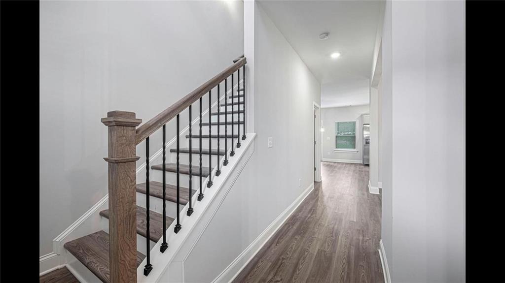 3792 Oak Rdg Drive, Unit HASTINGS Buford, GA 30519 - Photo 10 of 32 a view of staircase with wooden floor and white walls