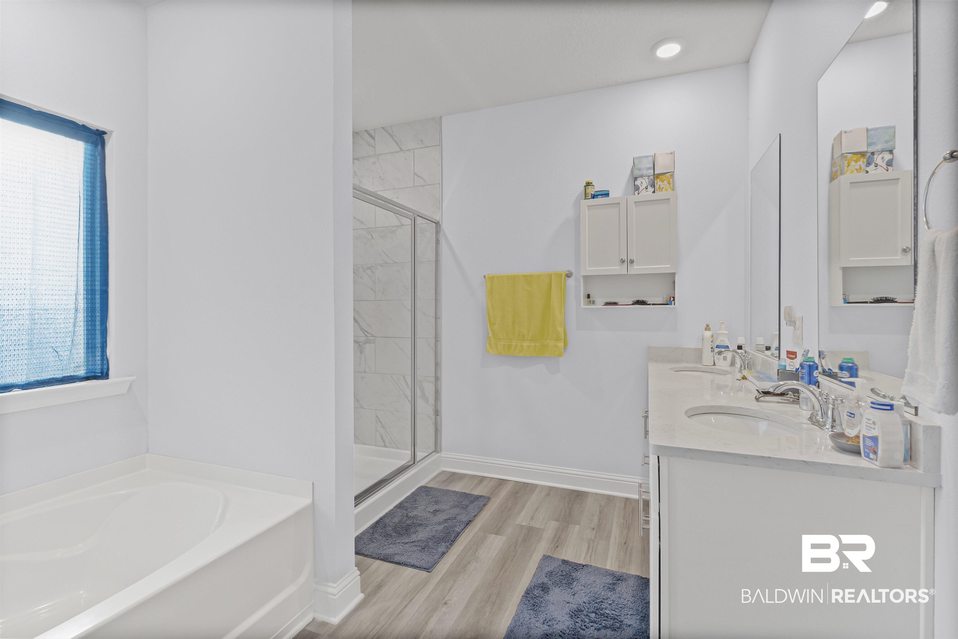10564 Heirloom Road South Mobile, AL 36608 - Photo 15 of 24 Bathroom featuring a bath, a marble finish shower, light wood-style floors, and double vanity