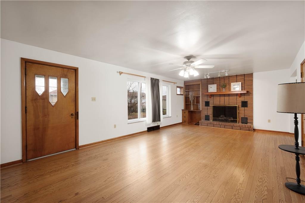 112 Washington Avenue Midway, PA 15060 - Photo 11 of 33 a view of a livingroom with wooden floor a fireplace and window