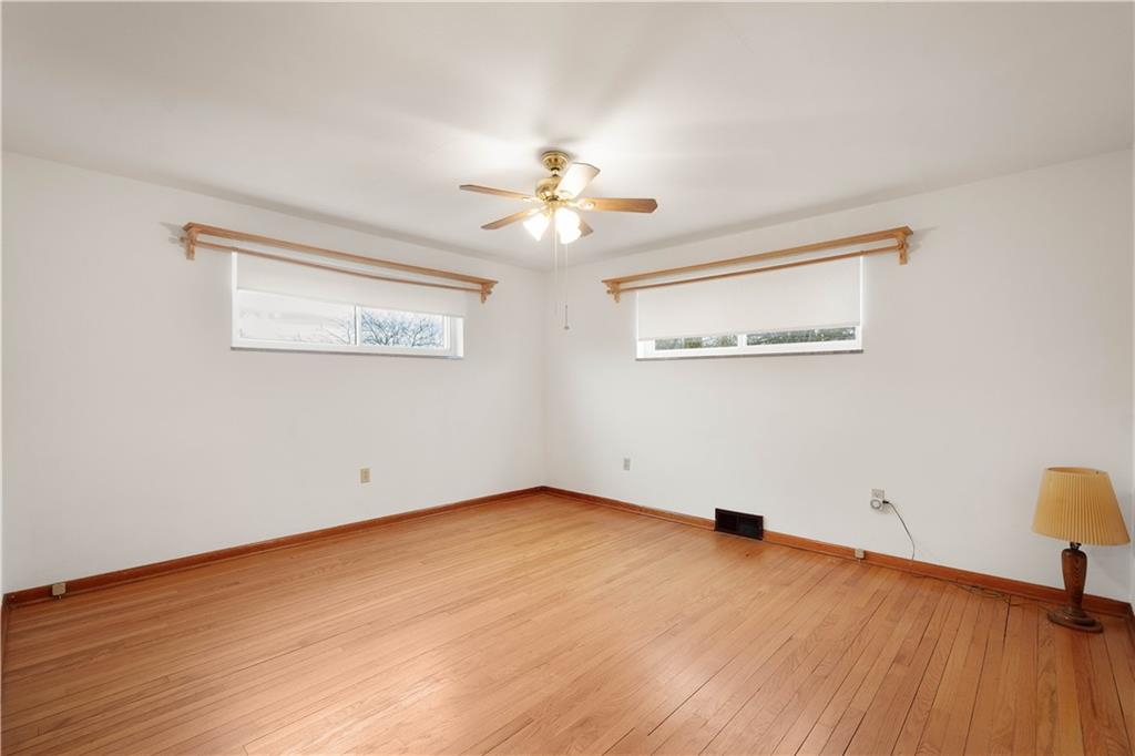 112 Washington Avenue Midway, PA 15060 - Photo 17 of 33 a view of a room with wooden floor and a ceiling fan