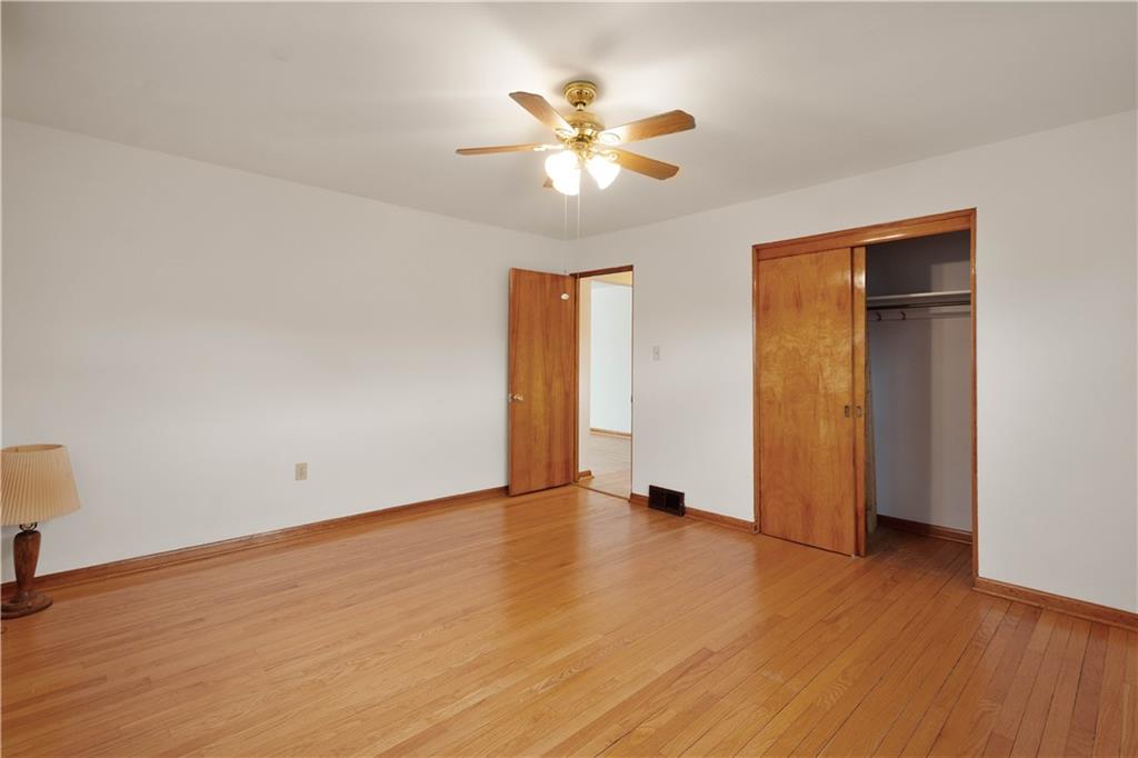 112 Washington Avenue Midway, PA 15060 - Photo 18 of 33 a view of an empty room with wooden floor and a ceiling fan