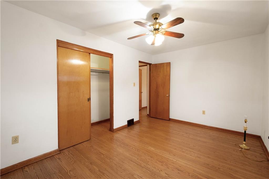 112 Washington Avenue Midway, PA 15060 - Photo 20 of 33 an empty room with wooden floor and a ceiling fan