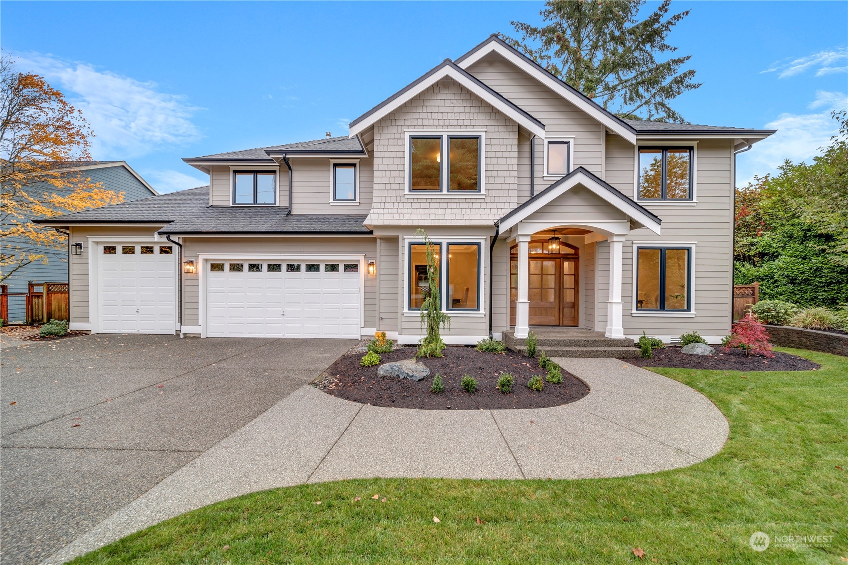 a front view of a house with a yard and garage