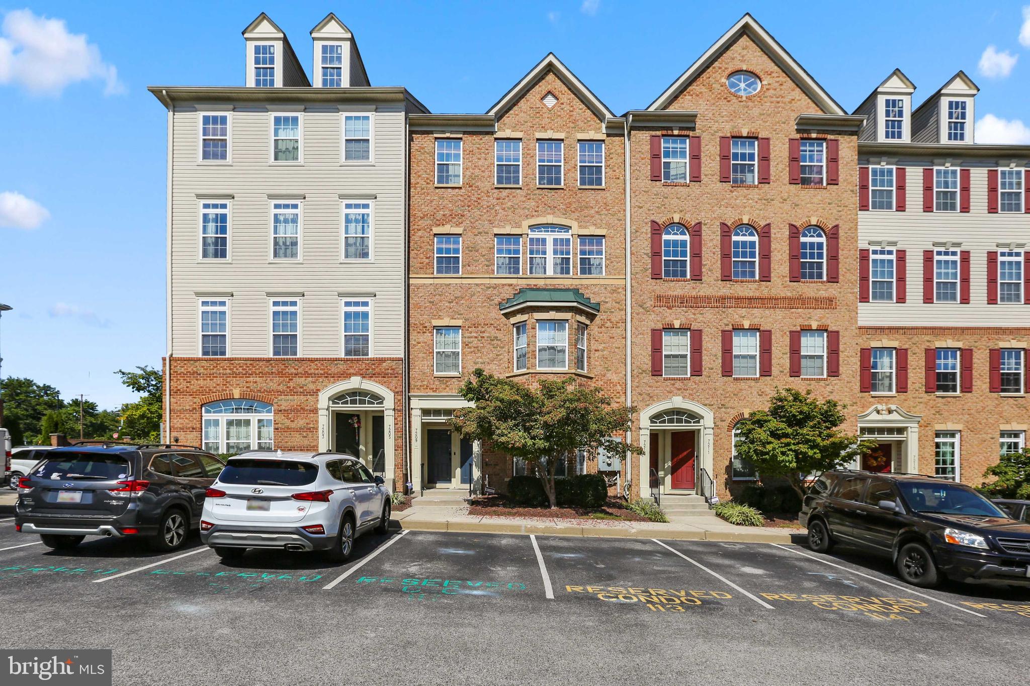 7209 Darby Downs, Unit 7209 Elkridge, MD 21075 - Photo 1 of 19 a front view of a residential apartment building with a yard