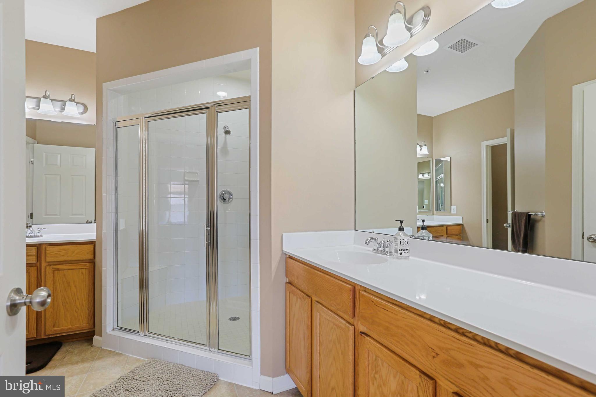 7209 Darby Downs, Unit 7209 Elkridge, MD 21075 - Photo 12 of 19 a bathroom with a sink a vanity and a mirror