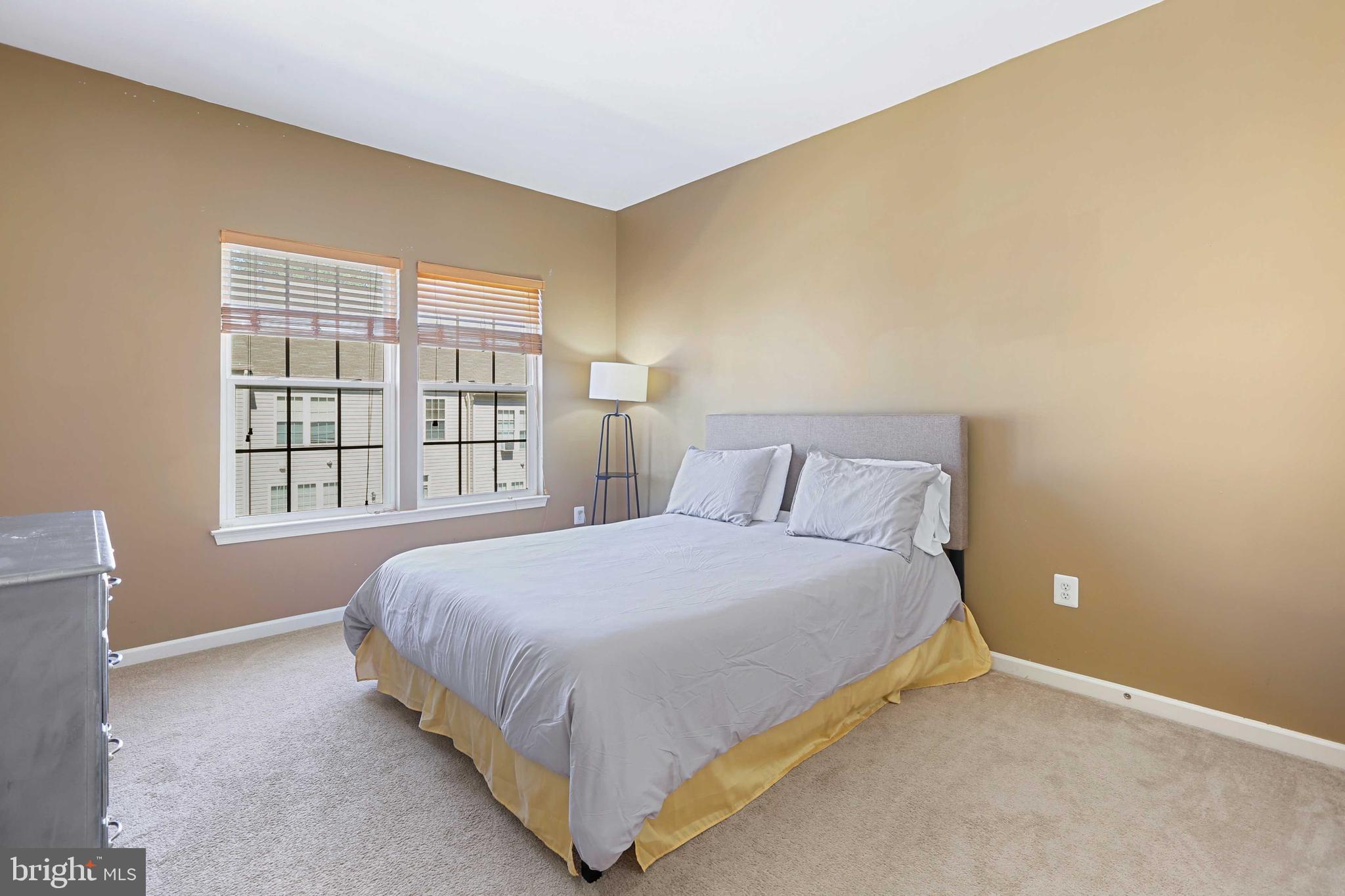 7209 Darby Downs, Unit 7209 Elkridge, MD 21075 - Photo 14 of 19 a large bed sitting in a bedroom next to a window