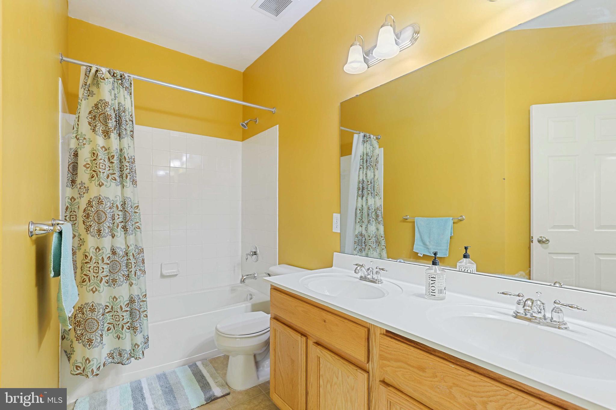7209 Darby Downs, Unit 7209 Elkridge, MD 21075 - Photo 16 of 19 a bathroom with a granite countertop sink toilet and shower