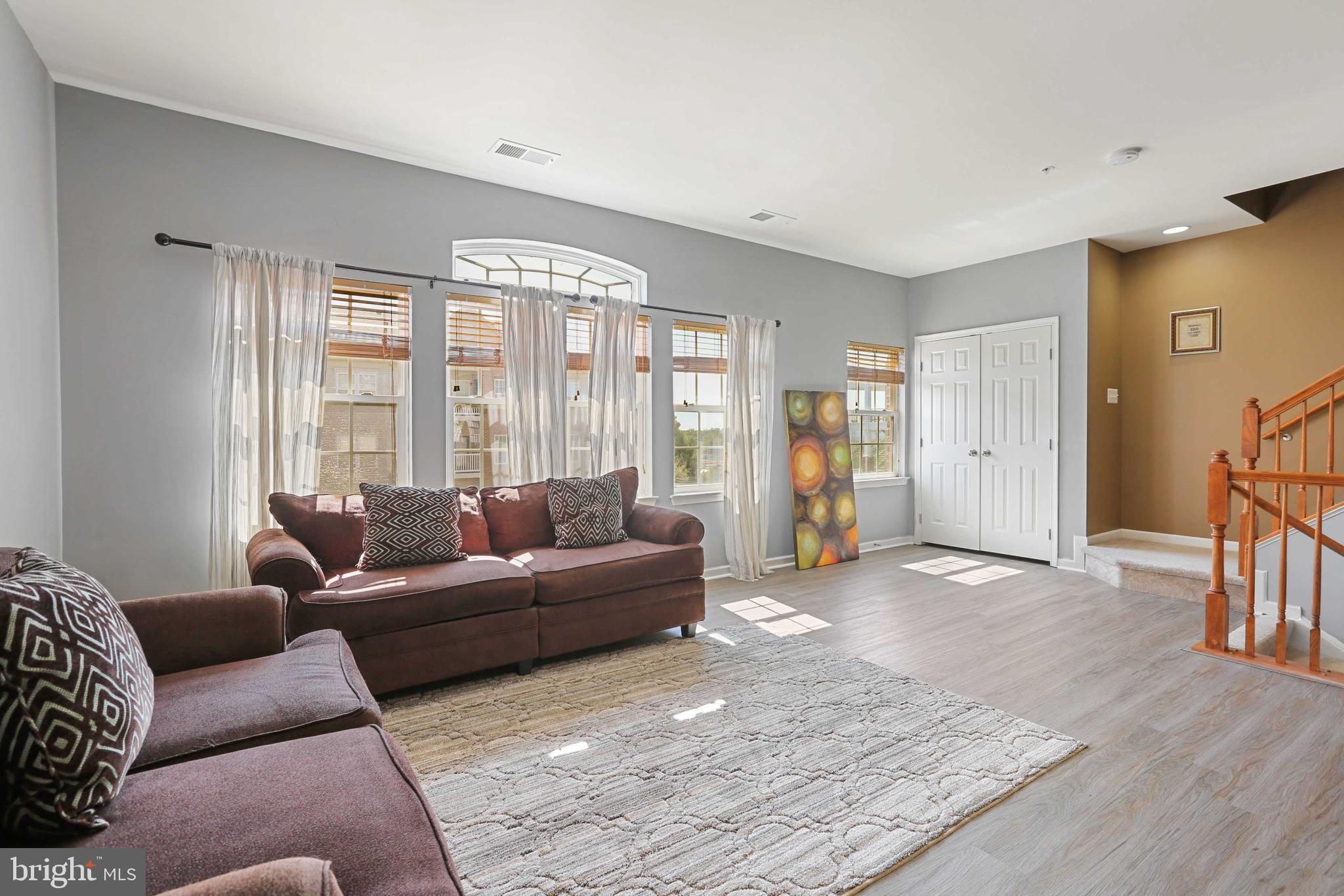 7209 Darby Downs, Unit 7209 Elkridge, MD 21075 - Photo 3 of 19 a living room with furniture and a large window
