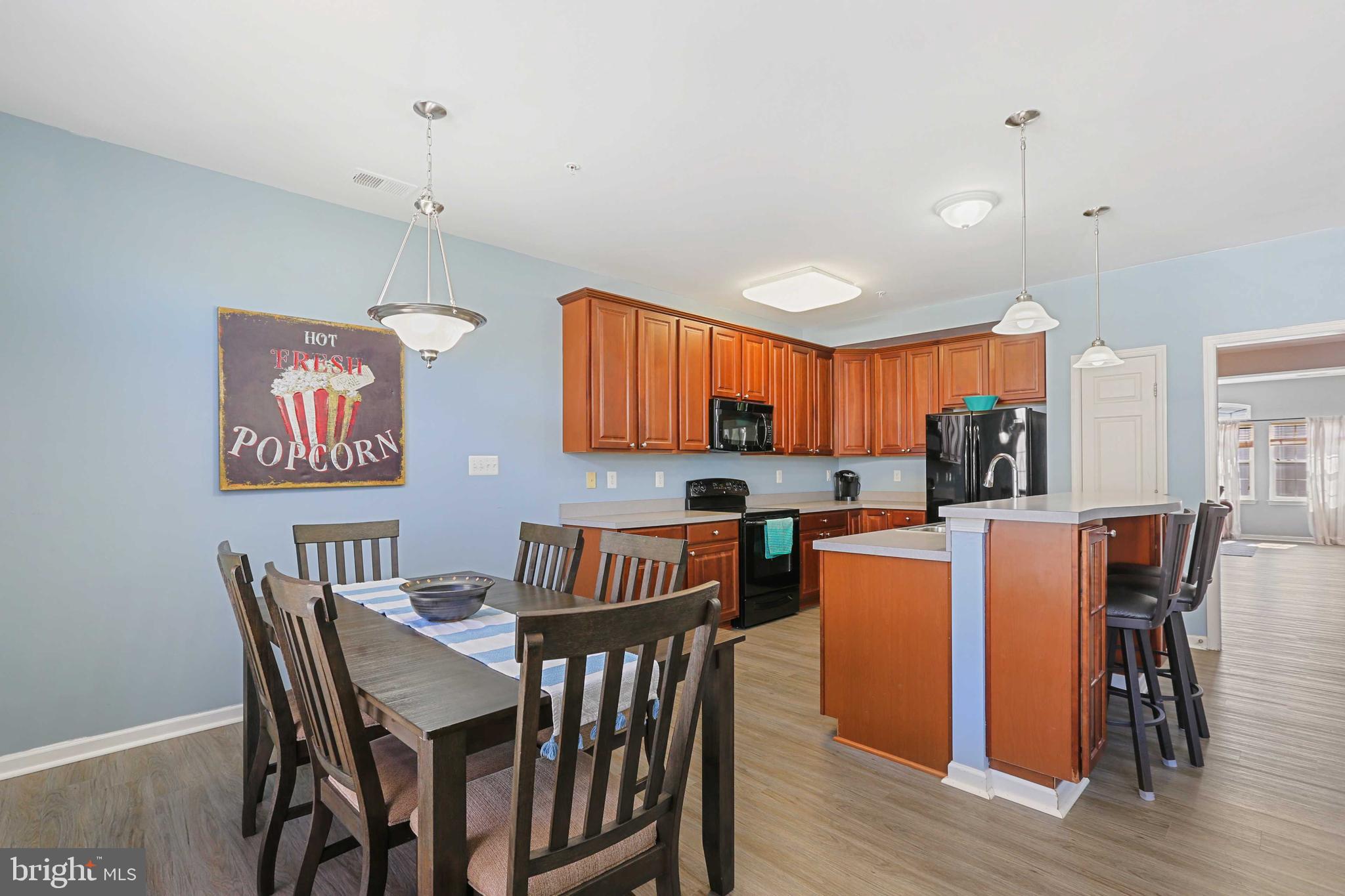 7209 Darby Downs, Unit 7209 Elkridge, MD 21075 - Photo 7 of 19 a view of a dining room with furniture and wooden floor