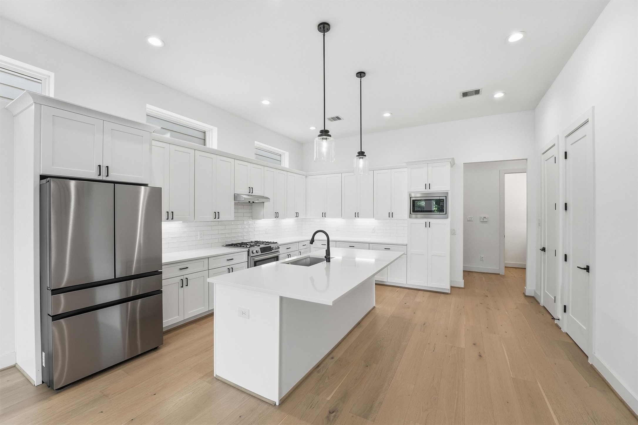 5004 Darling Street Houston, TX 77007 - Photo 8 of 41 Sleek kitchen featuring elegant quartz countertops.