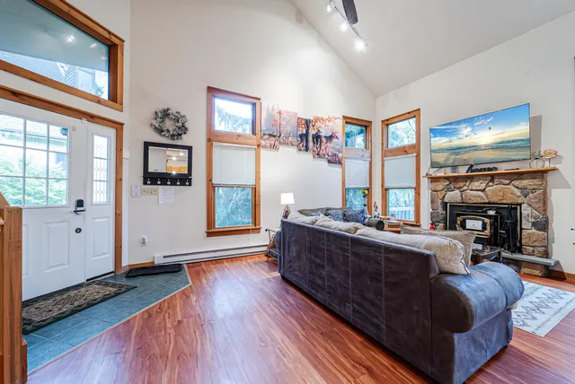a living room with furniture and a wooden floor