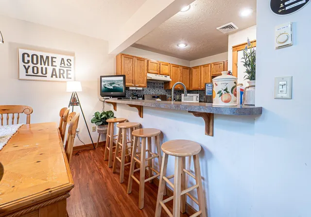 a kitchen with stainless steel appliances granite countertop a sink and a stove