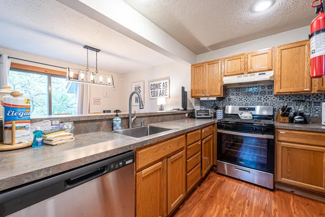 a bathroom with a granite countertop toilet sink and mirror