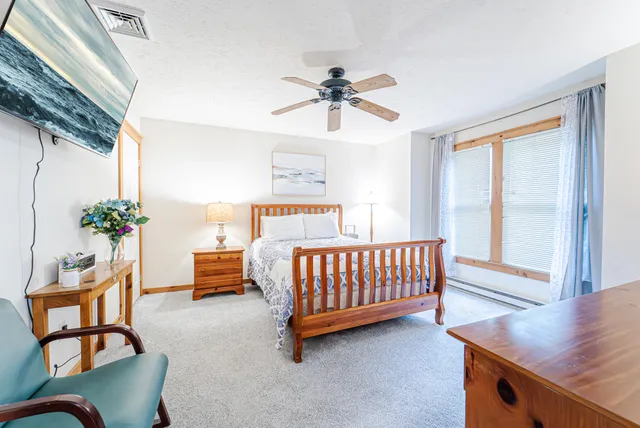 a bed sitting in a bedroom next to a window