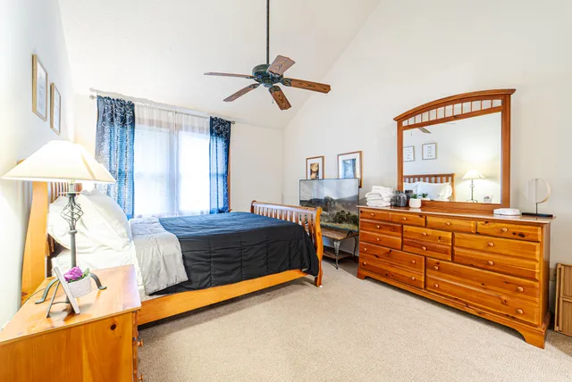 a bedroom with a bed and a chandelier