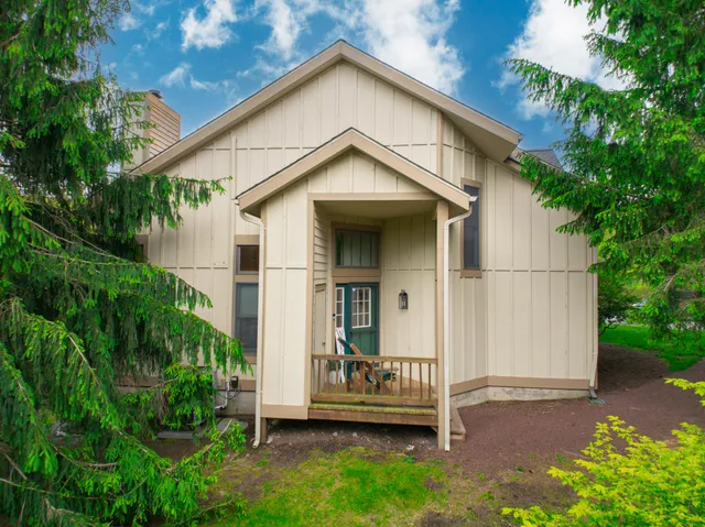 an aerial view of a house with garden space and a street view