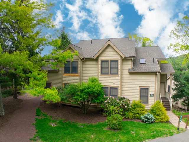 an aerial view of a house with a yard and garden