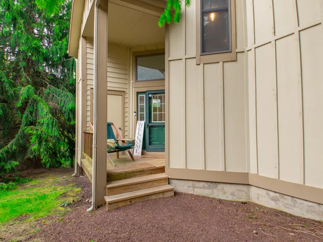 a living room with lots of furniture and a large window