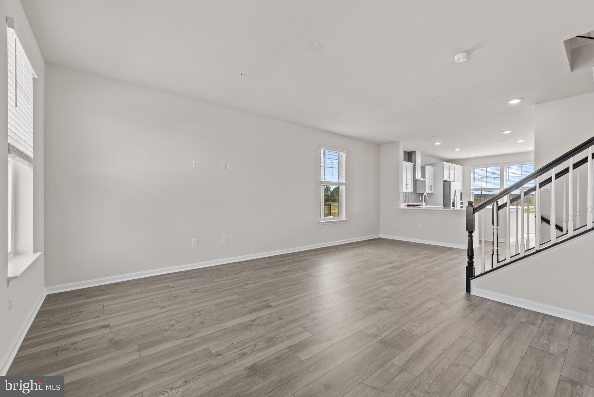 425 Ensemble Way Frederick, MD 21701 - Photo 19 of 37 a view of an empty room with wooden floor and a window