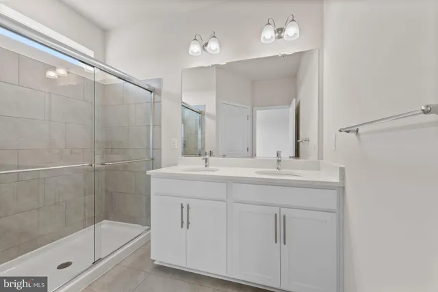 a bathroom with a shower sink and mirror