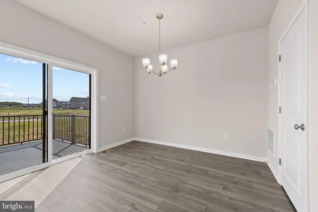 a view of a livingroom with wooden floor and a floor to ceiling window