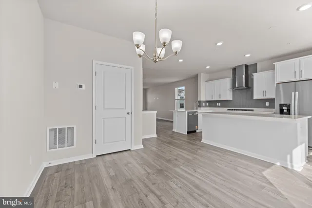 a view of kitchen with granite countertop cabinets and stainless steel appliances