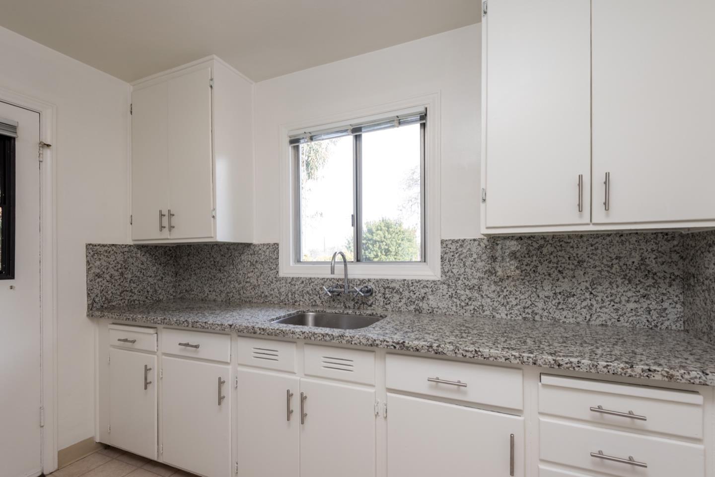 882 Middle Avenue Menlo Park, CA 94025 - Photo 11 of 22 a kitchen with granite countertop white cabinets and a window
