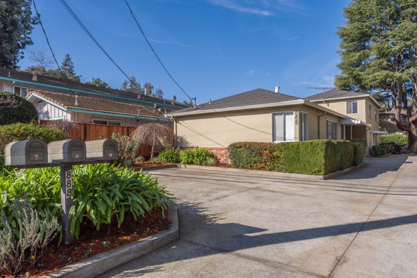 882 Middle Avenue Menlo Park, CA 94025 - Photo 2 of 22 a front view of a house with a yard and potted plants
