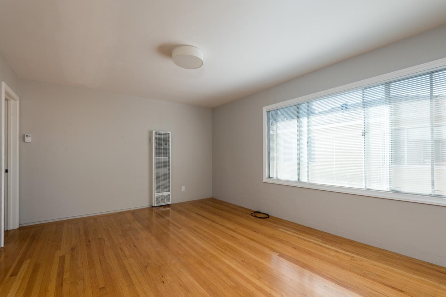 882 Middle Avenue Menlo Park, CA 94025 - Photo 5 of 22 an empty room with wooden floor and windows