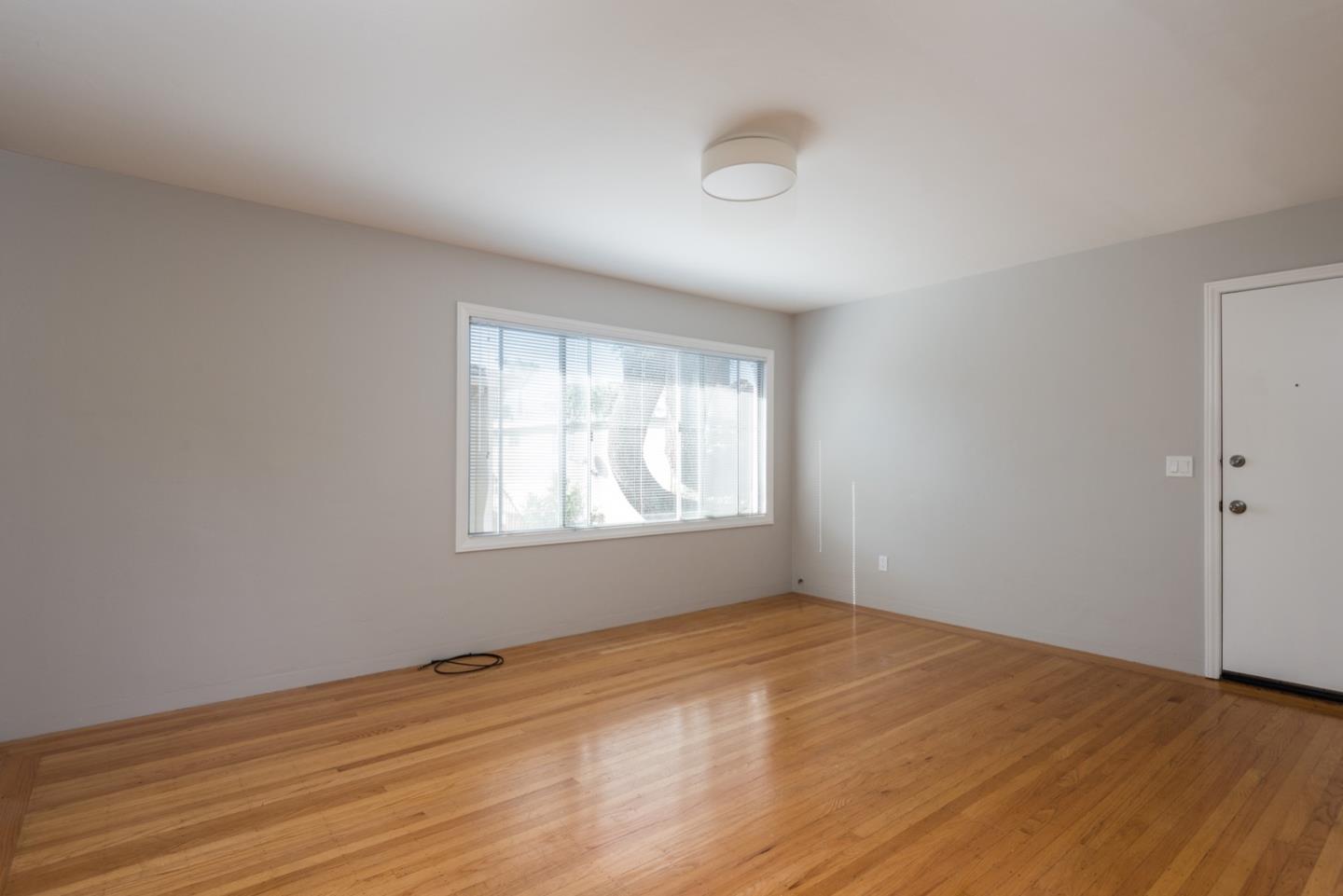882 Middle Avenue Menlo Park, CA 94025 - Photo 6 of 22 an empty room with wooden floor and windows