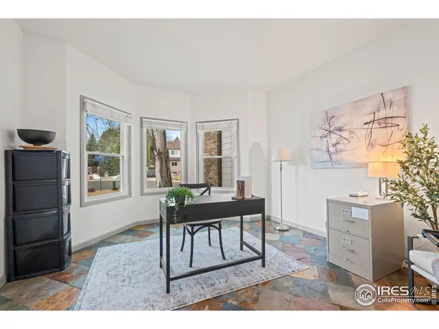 a kitchen with stainless steel appliances kitchen island a table chairs in it and white cabinets