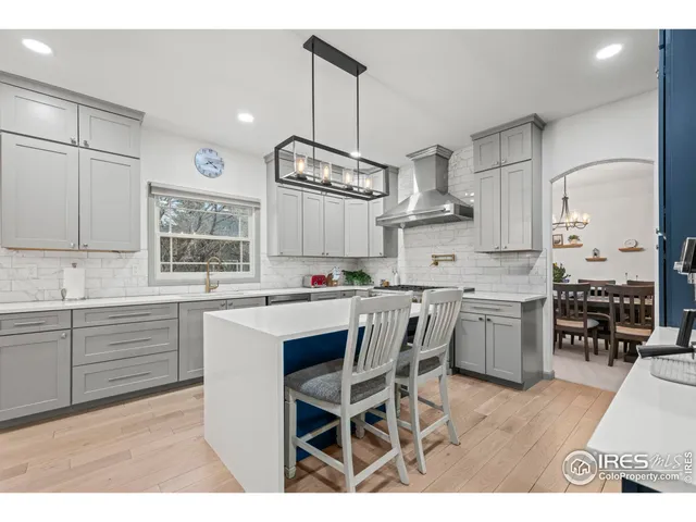 a kitchen with a refrigerator and a sink