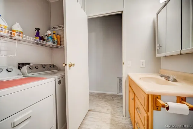 a utility room with sink dryer and washer