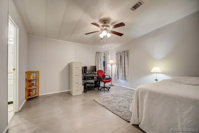 a bed room with a bed and a tv