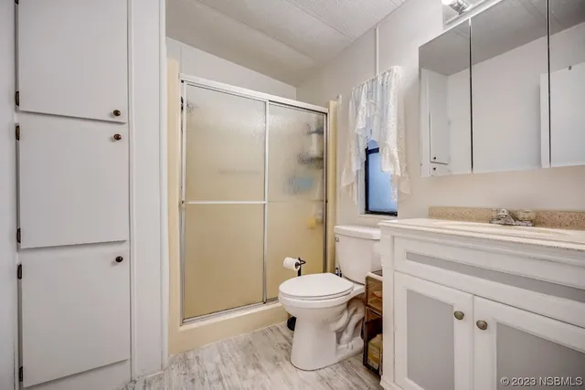 a bathroom with a toilet and a shower