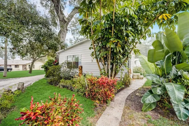 a front view of a house with a yard and fountain