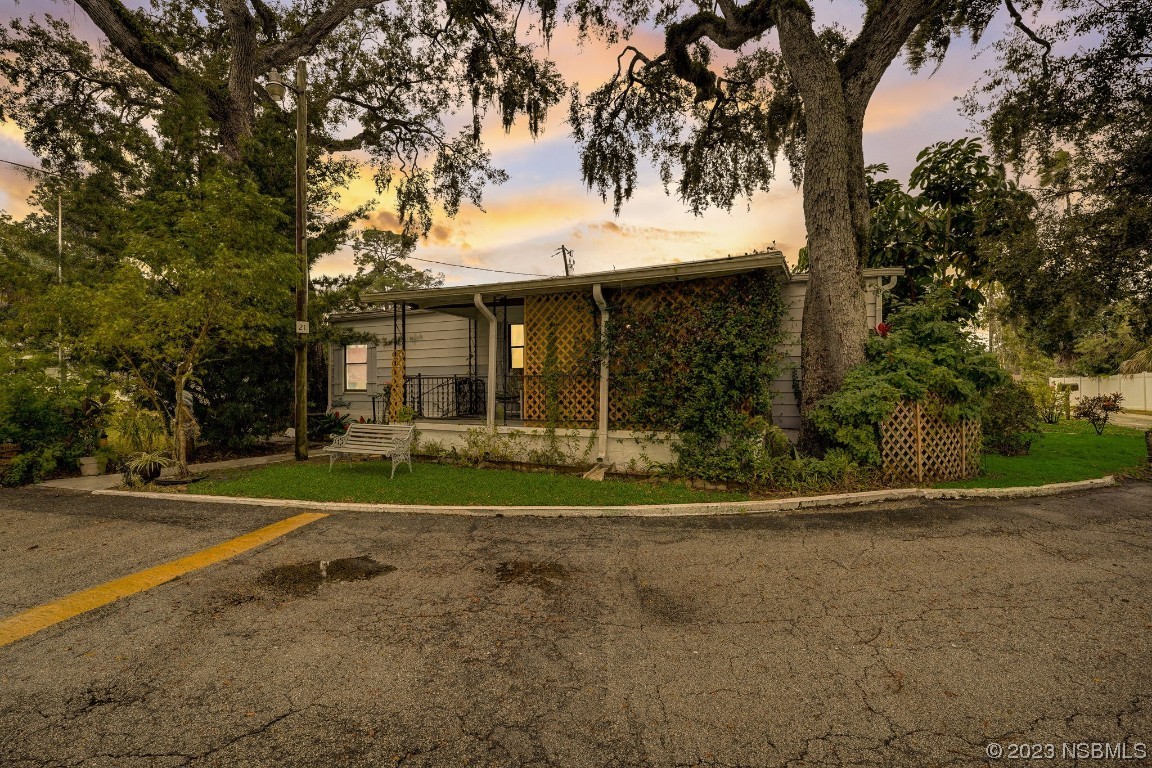 2201 South Ridgewood Avenue, Unit 21 Edgewater, FL 32141 - Photo 36 of 38 a front view of a house with a yard