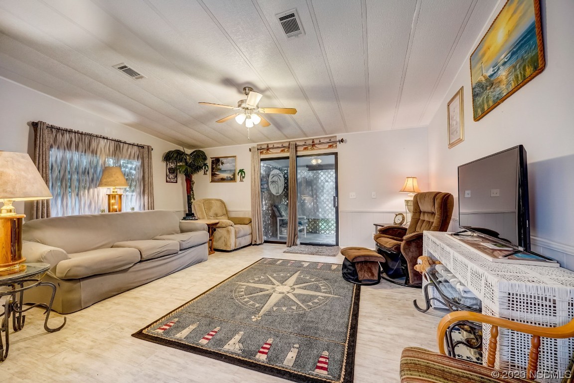 2201 South Ridgewood Avenue, Unit 21 Edgewater, FL 32141 - Photo 6 of 38 a living room with furniture and a flat screen tv