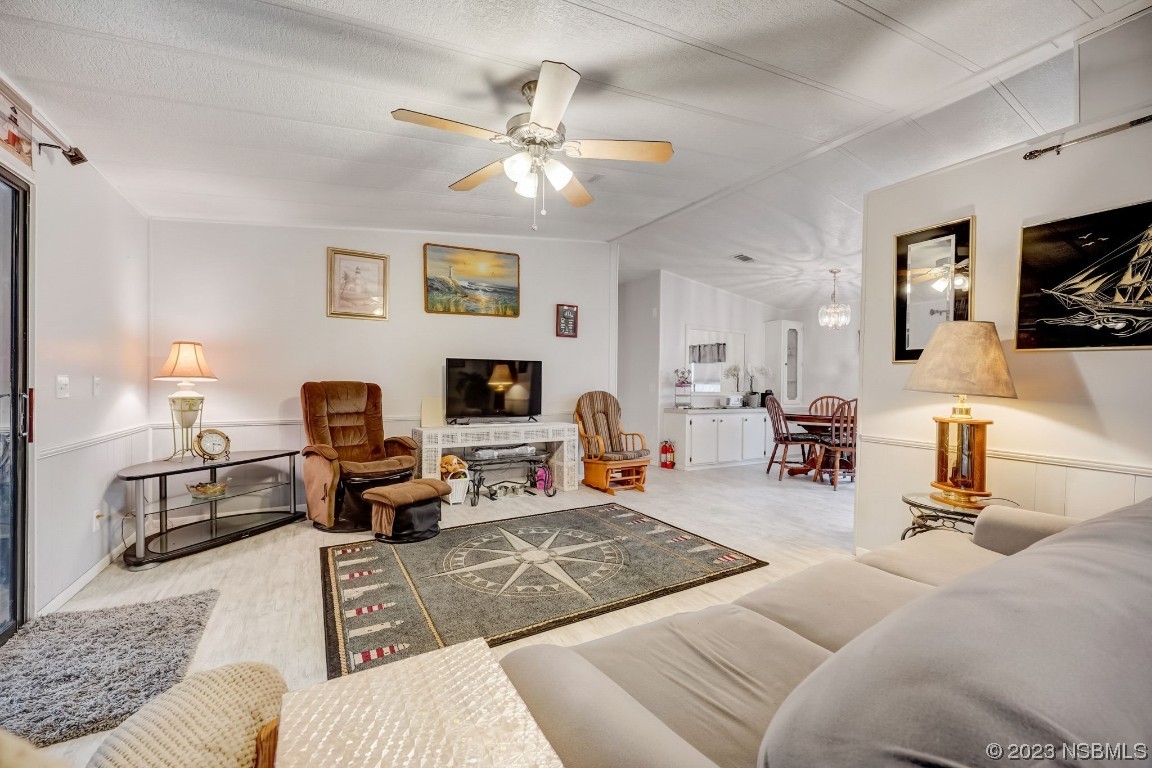 2201 South Ridgewood Avenue, Unit 21 Edgewater, FL 32141 - Photo 9 of 38 a living room with furniture a flat screen tv and a fireplace