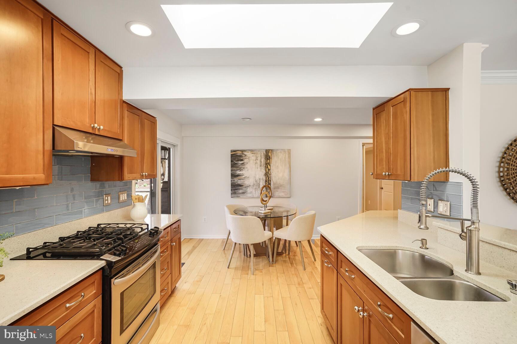 8618 Crestview Drive Fairfax, VA 22031 - Photo 14 of 33 a kitchen with a sink stove and wooden cabinets
