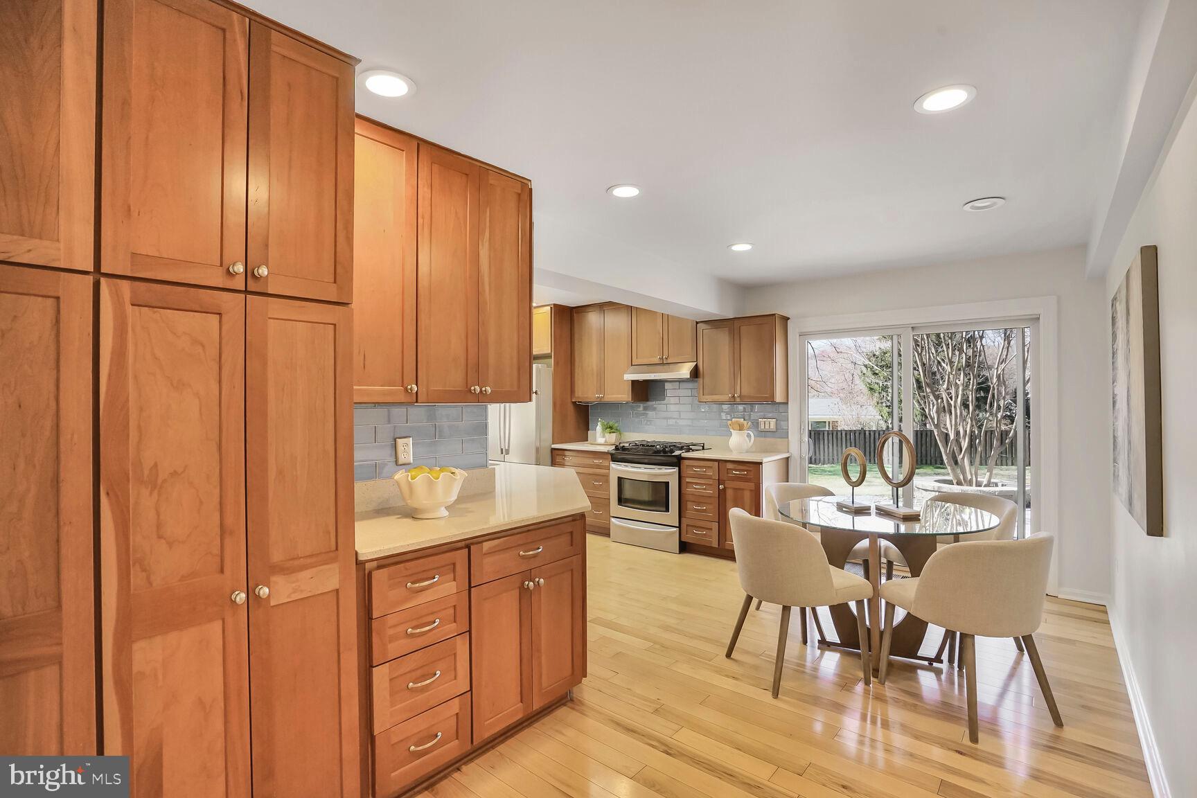 8618 Crestview Drive Fairfax, VA 22031 - Photo 17 of 33 a kitchen with a refrigerator a stove a sink dishwasher with a dining table and chairs