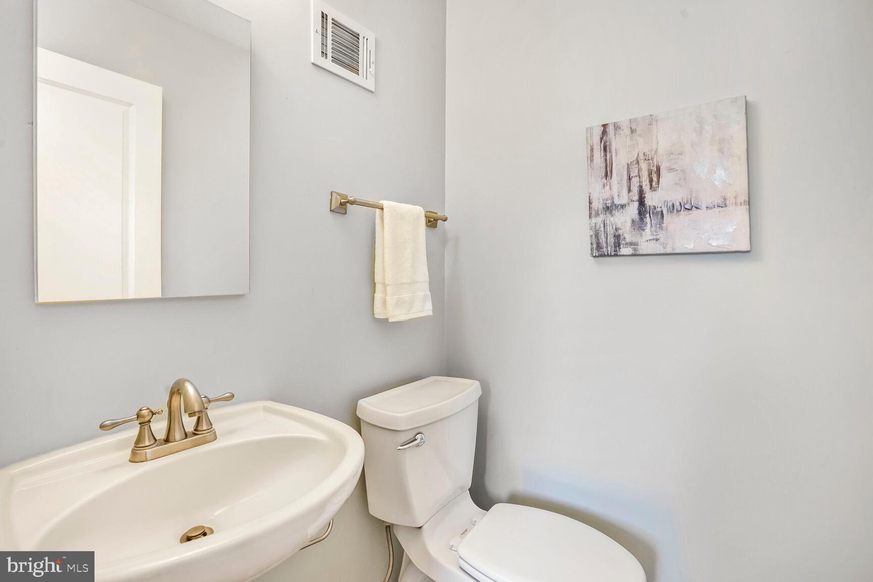 8618 Crestview Drive Fairfax, VA 22031 - Photo 20 of 33 a white toilet sitting next to a bathroom sink