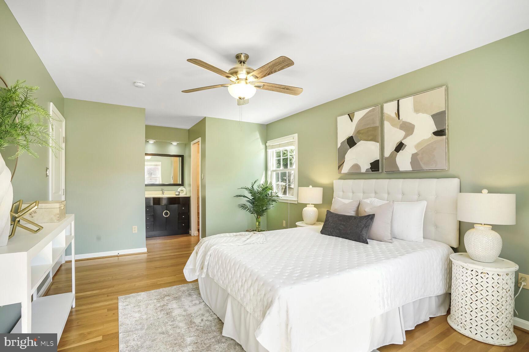 8618 Crestview Drive Fairfax, VA 22031 - Photo 22 of 33 a bedroom with a large bed and a chandelier